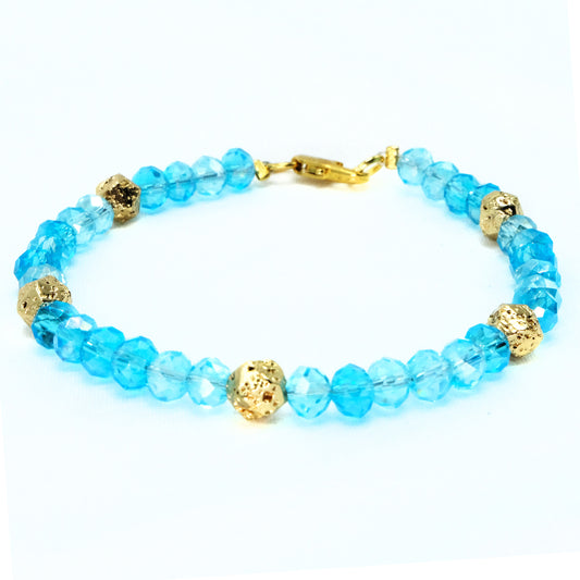 6mm Light Blue Glass Crystal with gold spacer beads, beaded bracelet. Gold clasp.